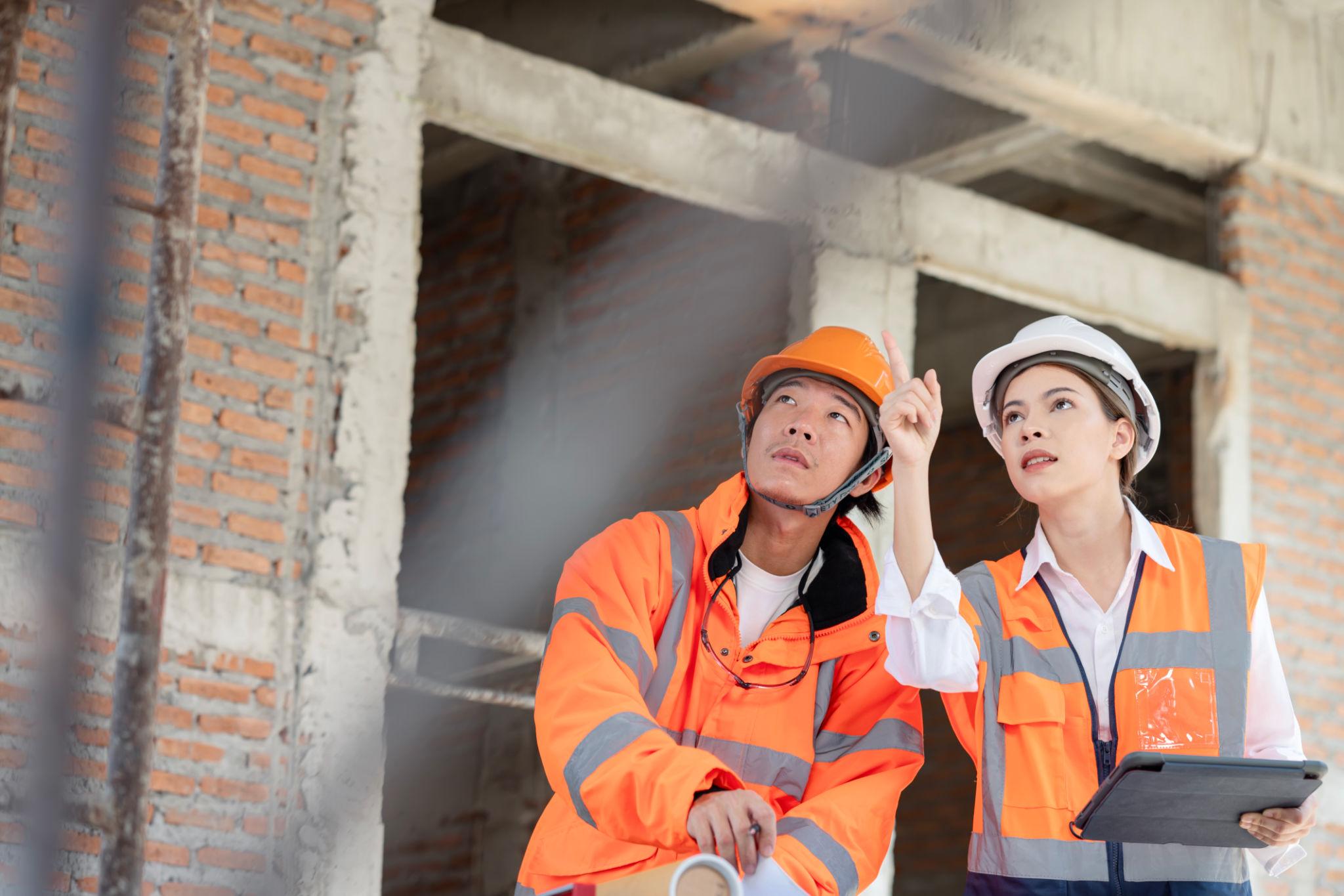 Construction supervisors reviewing site documentation together on a tablet