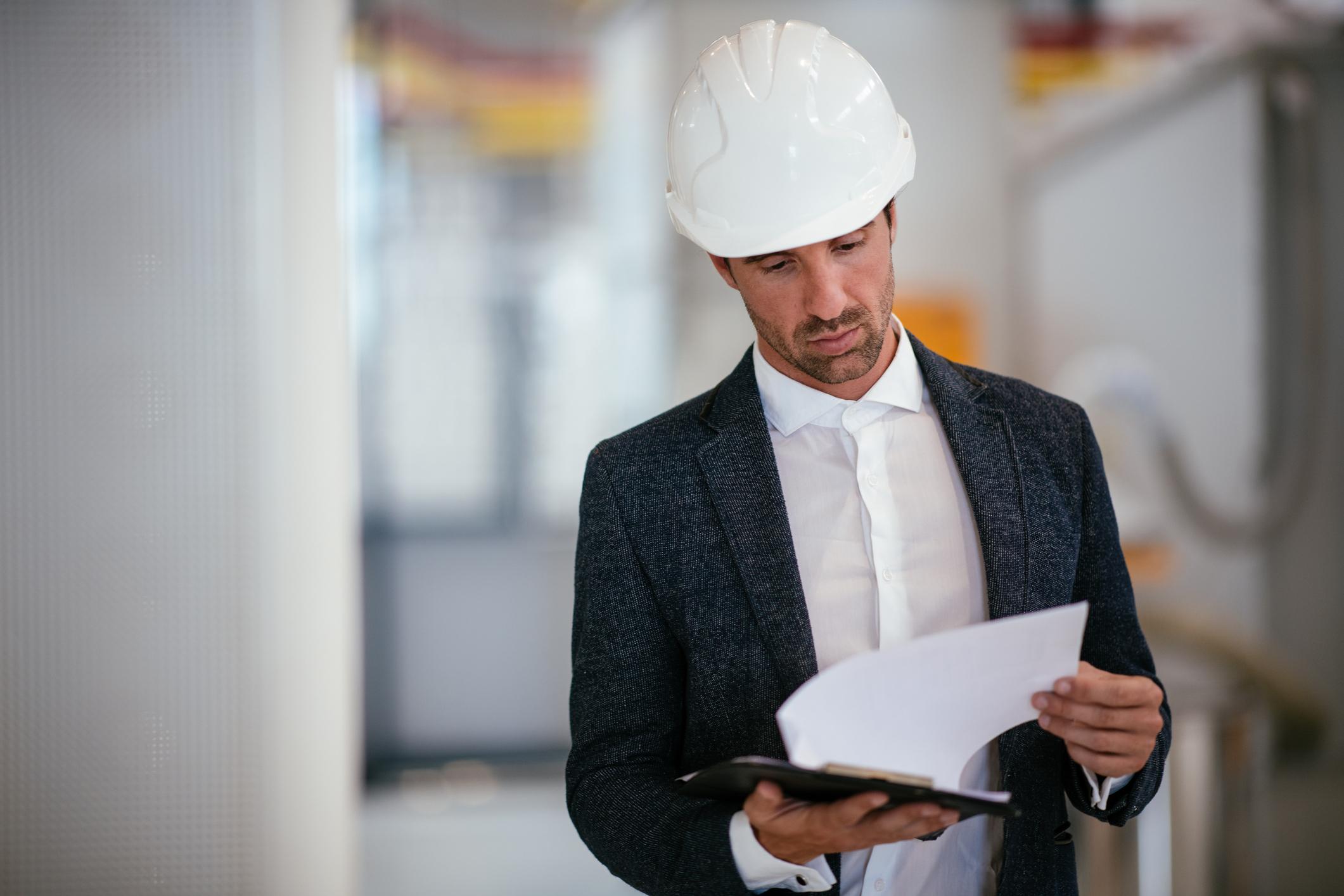 Auditor reviewing management system documentation