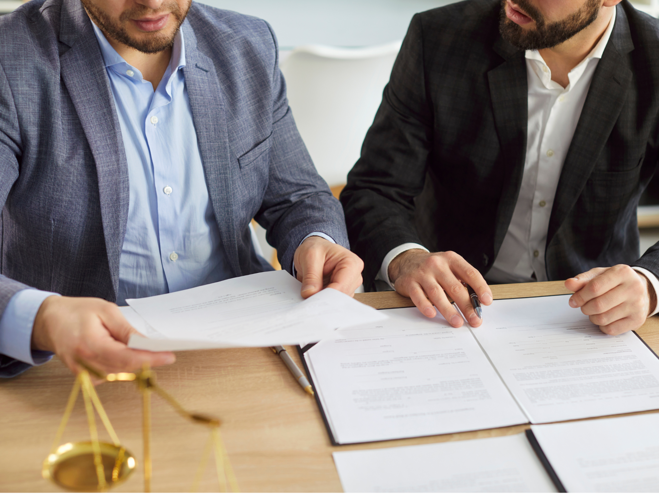 Business professionals reviewing supplier compliance documents together