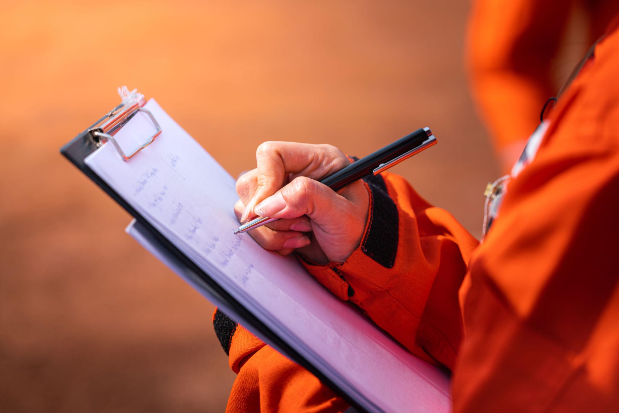 What Is CHAS Accreditation? Requirements, Levels and How to Apply 2 Hand completing a checklist on a clipboard
