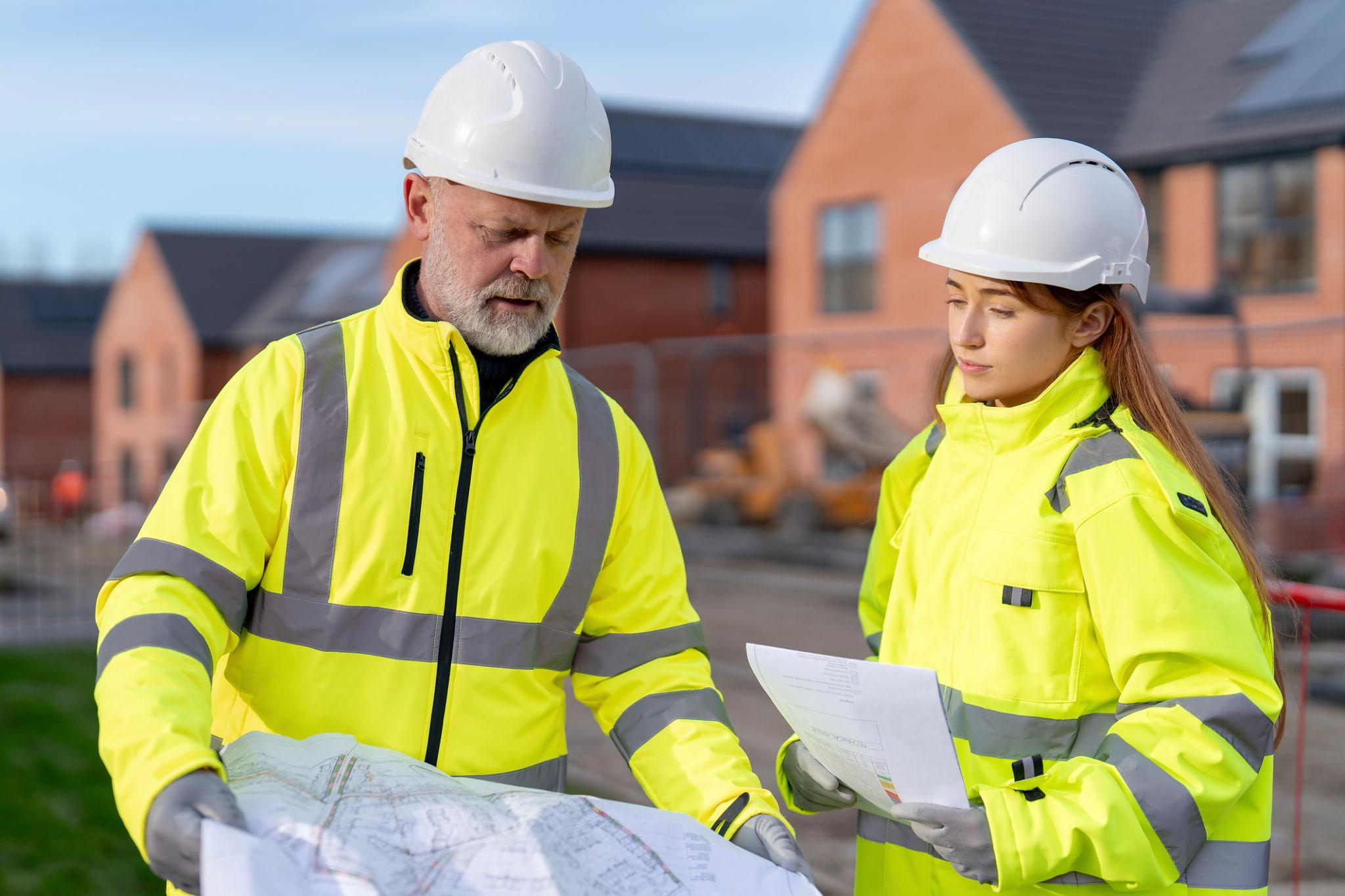 What Is CHAS Accreditation? Requirements, Levels and How to Apply 1 Construction workers discussing site safety and CHAS accreditation requirements