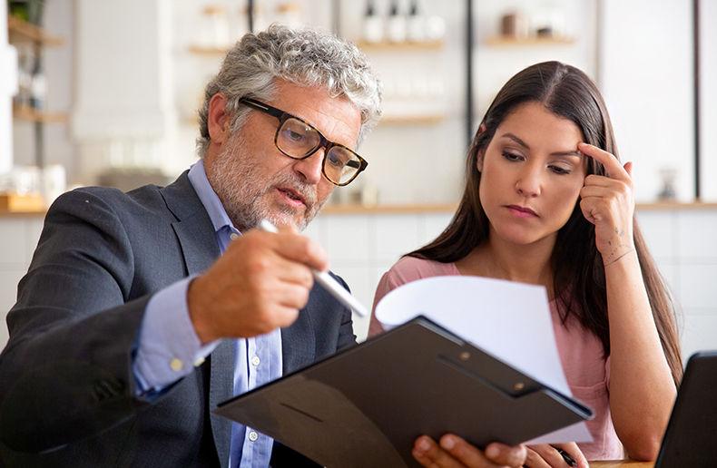 What Is CHAS Accreditation? Requirements, Levels and How to Apply 3 Consultant reviewing compliance evidence with a client