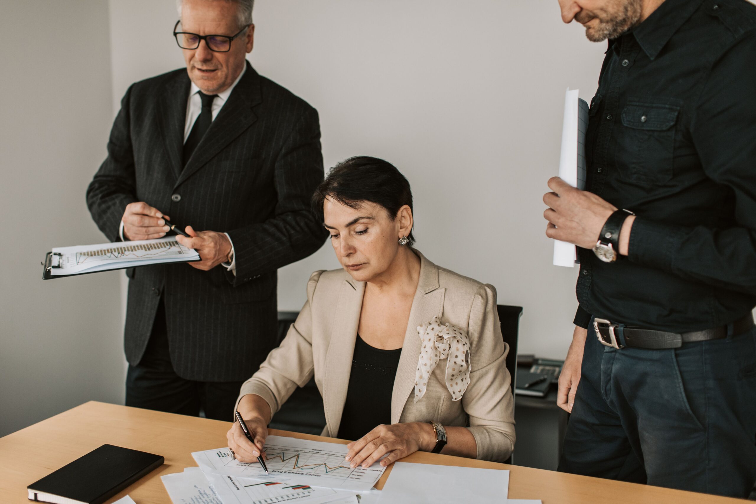 Business owner and compliance adviser reviewing requirements